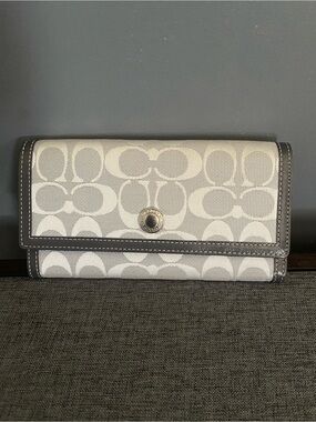Coach Signature Canvas Trifold Wallet in Light and charcoal Gray.